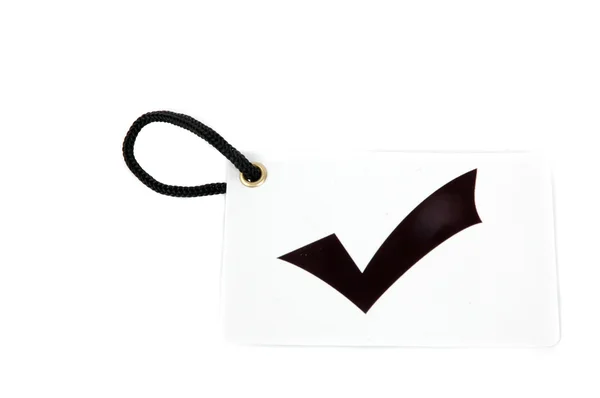 Etiqueta de papel branco rotulada com símbolo de marca de seleção — Fotografia de Stock