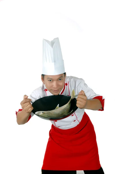 Chef holding raw fish on a frying pan — Stock Photo, Image