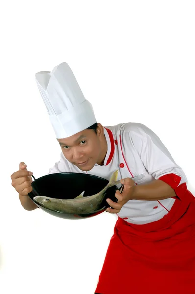 Chef present raw fish on a black frying — Stock Photo, Image