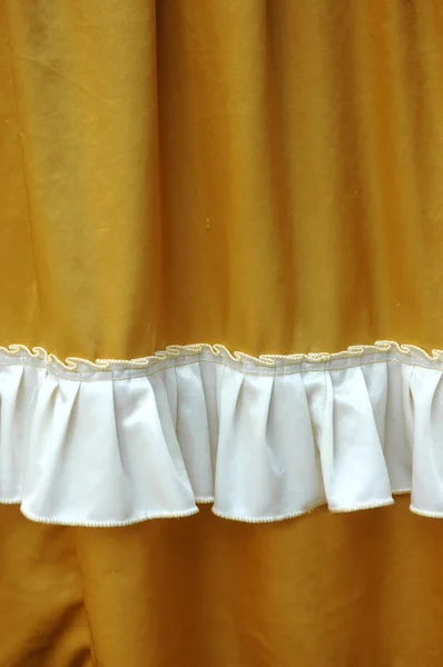 Gyllene tyg dekoration med vita fransar — Stockfoto