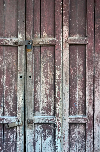 Wooden door with a faded paint — Stock Photo, Image