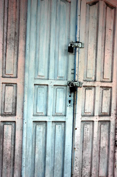 Wooden door with a faded paint — Stock Photo, Image