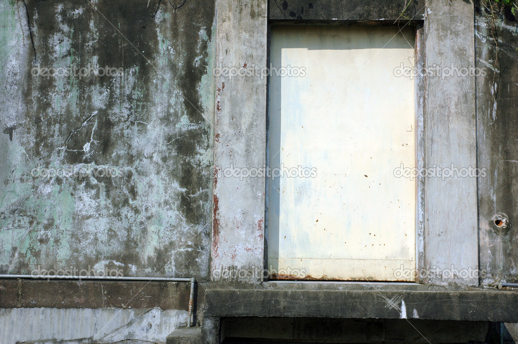 White rusty iron door with concrete wall