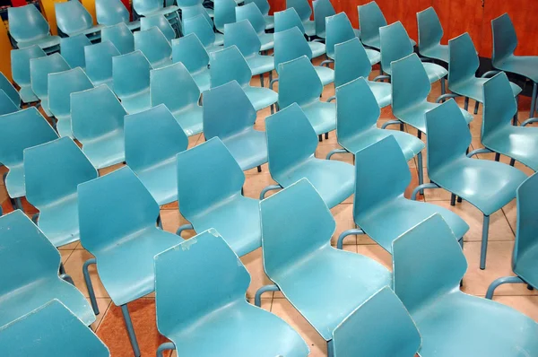 Arrangement of rows of small blue chairs — Stock Photo, Image