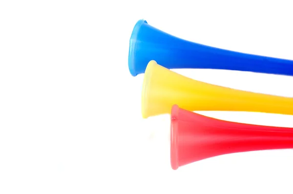Três trompete de plástico colorido — Fotografia de Stock