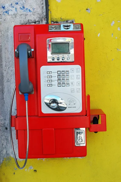 A red public telephone coin at downtown — Stock Photo, Image