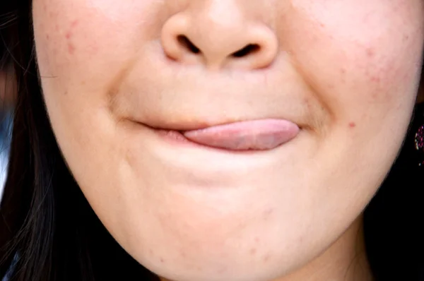 Teenage girl licking her lip — Stock Photo, Image