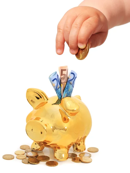 Baby's hand with coin and piggybank. — Stock Photo, Image