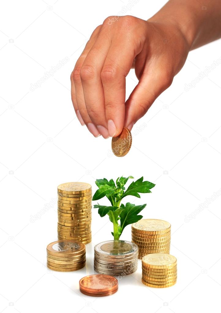 Hand with coin and plant.