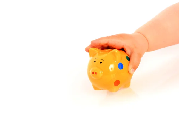 Kid hand and piggybank. — Stock Photo, Image