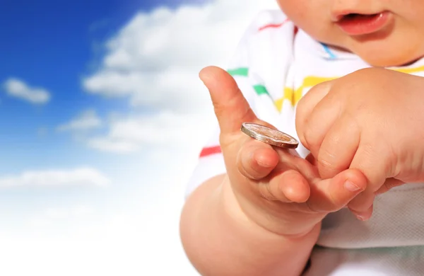 Baby and coin. — Stock Photo, Image