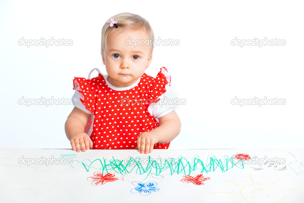 Little girl drawing with crayons