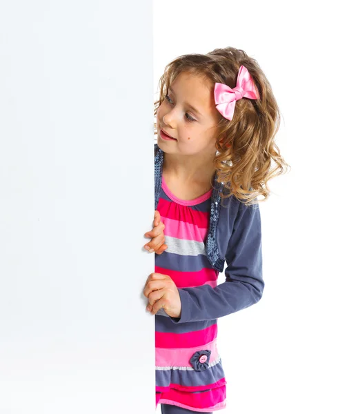 Young girl looking down at a blank board Stock Image