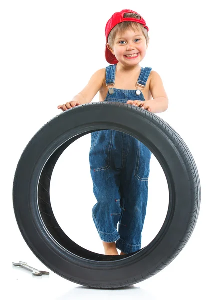 Little mechanic with a tire — Stock Photo, Image