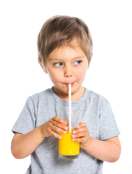 Portrait of little boy drinking orange juice — Stock Photo, Image