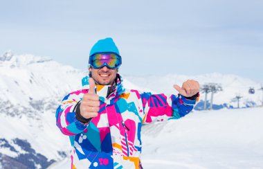 Young man with skis and a ski wear