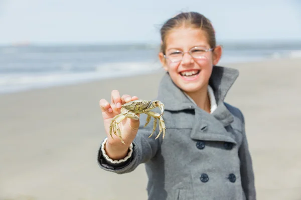 Adorable happy girl holding crab — Stock Photo, Image