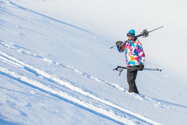 Young man with skis and a ski wear