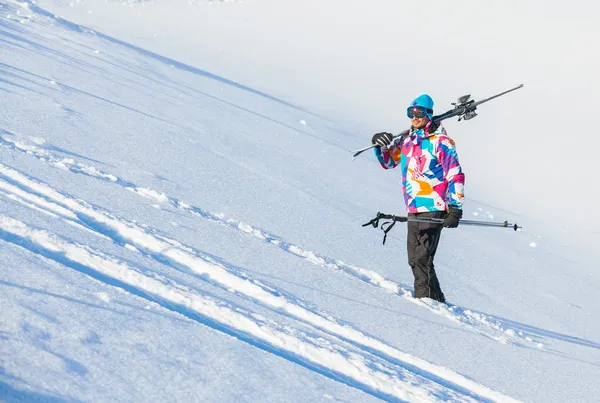 Young man with skis and a ski wear — Stok fotoğraf