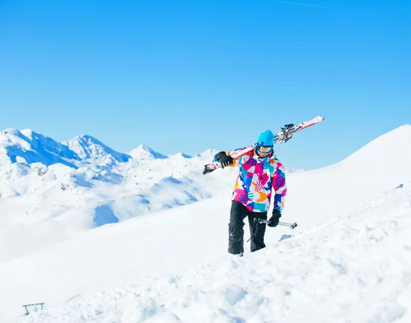 Young man with skis and a ski wear — Stok fotoğraf