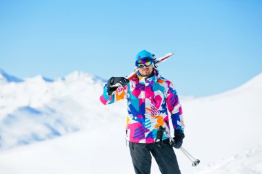 Young man with skis and a ski wear