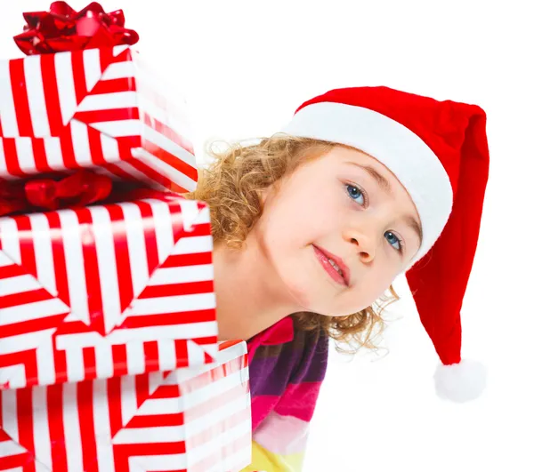 Little girl in Santa's hat with gift box Royalty Free Stock Photos