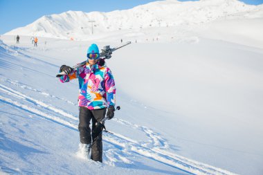 Young man with skis and a ski wear
