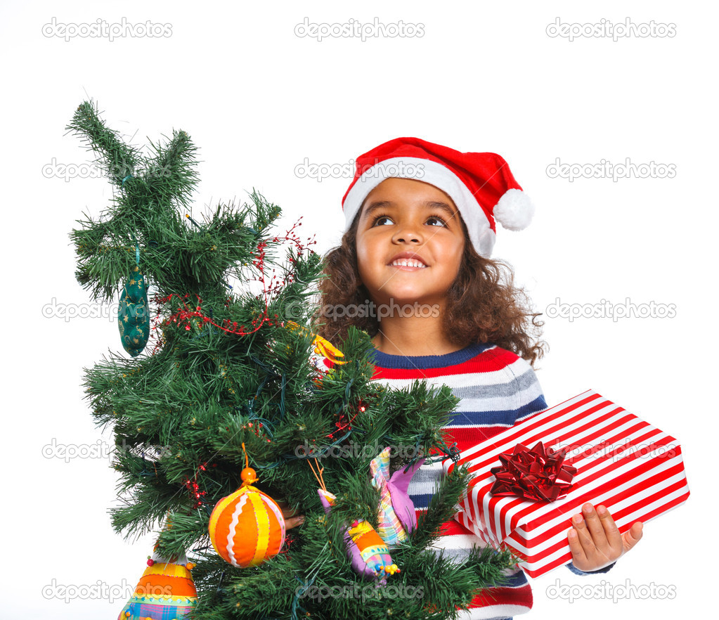 Little girl in Santa's hat with gift box
