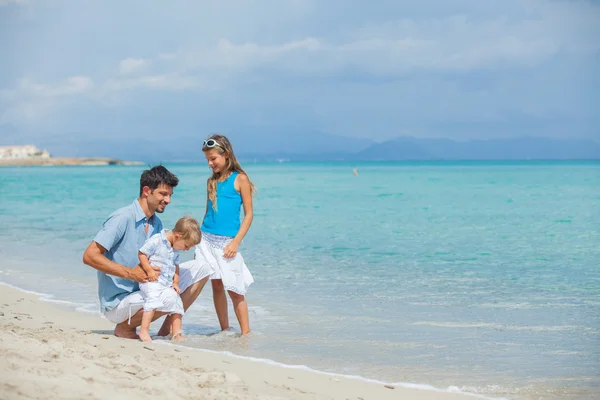 Padre con sus dos hijos en la playa — Foto de Stock