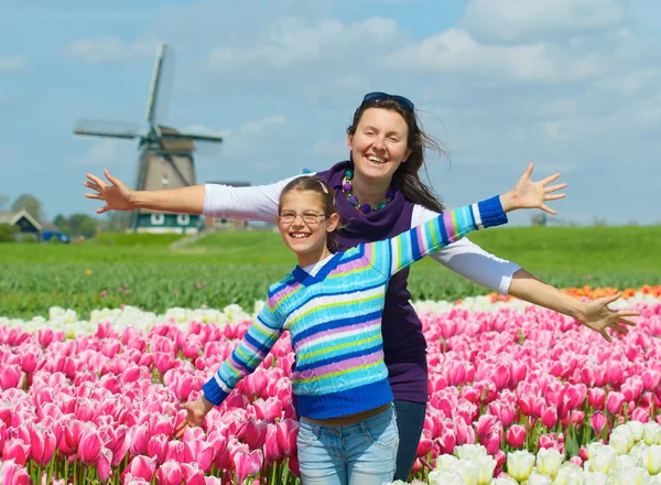 Niño con madre en el campo de los tulipanes —  Fotos de Stock