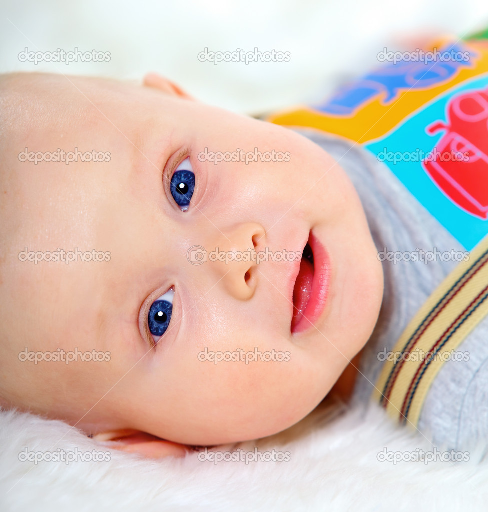 Closeup portrait of cute baby boy on white background