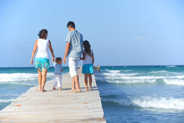 Family on wooden jetty.