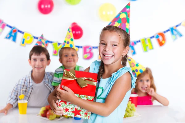 Girl with giftbox at birthday party — Stock Photo, Image