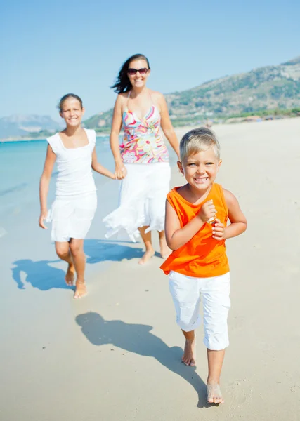 Cute boy with sister and mother on the beach Royalty Free Stock Images