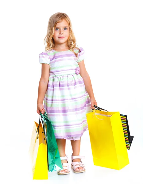 Flicka med shoppingväskor — Stockfoto