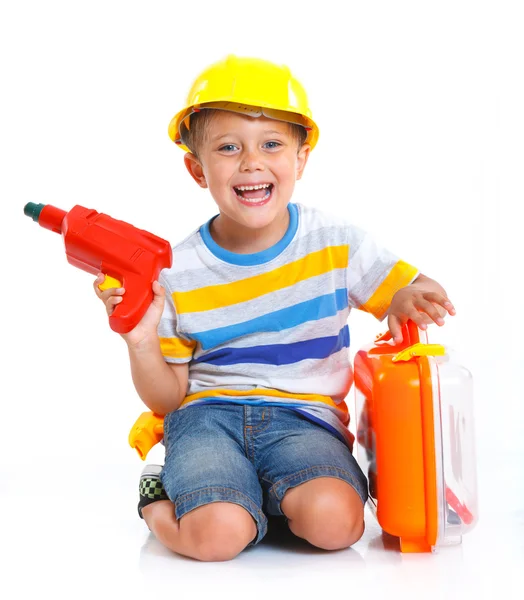 Junge mit Helm spielt im Bauarbeiter — Stockfoto