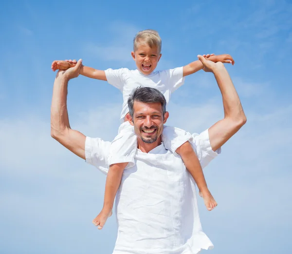 Father and son having fun on the beach — Stock Photo, Image