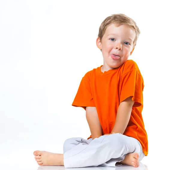 Lycklig pojke sitter på golvet — Stockfoto