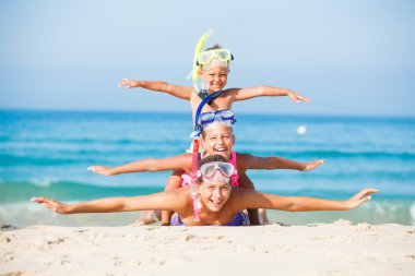 three happy children on beach... clipart