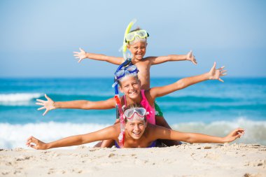 three happy children on beach... clipart