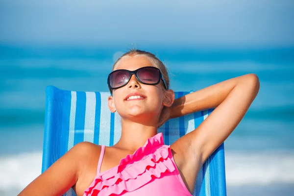 Girl relaxing on deck chair Stock Image