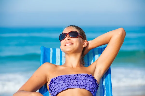 Girl relaxing on deck chair Royalty Free Stock Photos