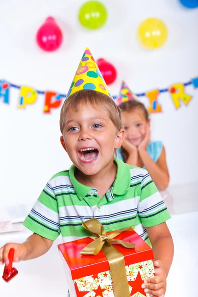 Menino com caixa de presente na festa de aniversário — Fotografia de Stock