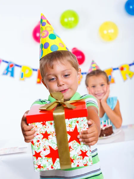 Boy with giftbox at birthday party — Stock Photo, Image