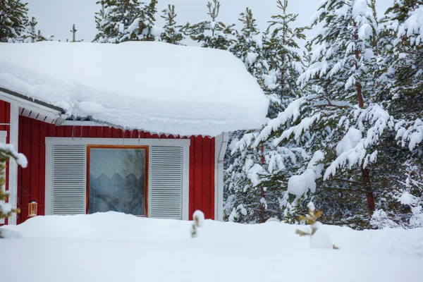 Red wooden finnish house in the forest. — Stock Photo, Image