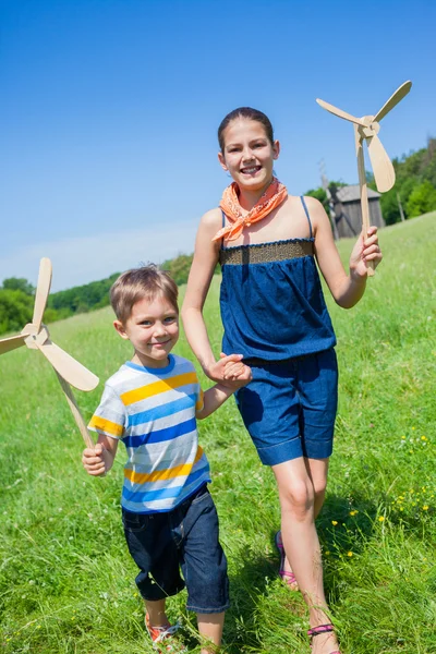 Kinder im Sommertag halten Windmühle in der Hand — Stockfoto