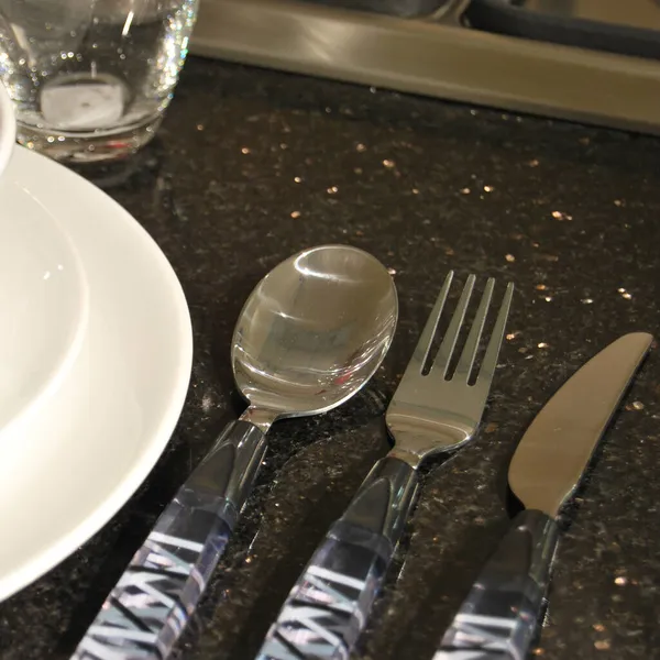 Cutlery Spoon Next Empty White Porcelain Plates Black Granite Table — Stock Photo, Image