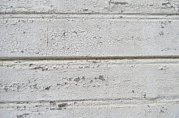 旧木地板上开裂的剥皮白色涂料背景 开裂的风化涂料图案 — 图库照片