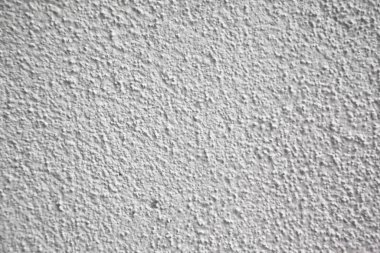 Kabataslak yüzeyi olan beyaz ve gri duvar dokusu, iki renk duvar alçısı.