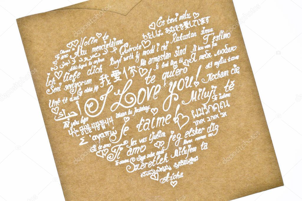 I love you phrase written in heart shape in all languages on cardboard envelope, wedding invitation
